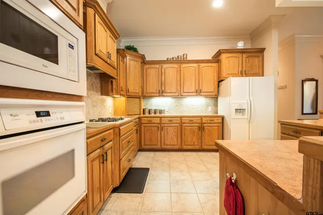 a kitchen with stainless steel appliances a stove microwave and cabinets