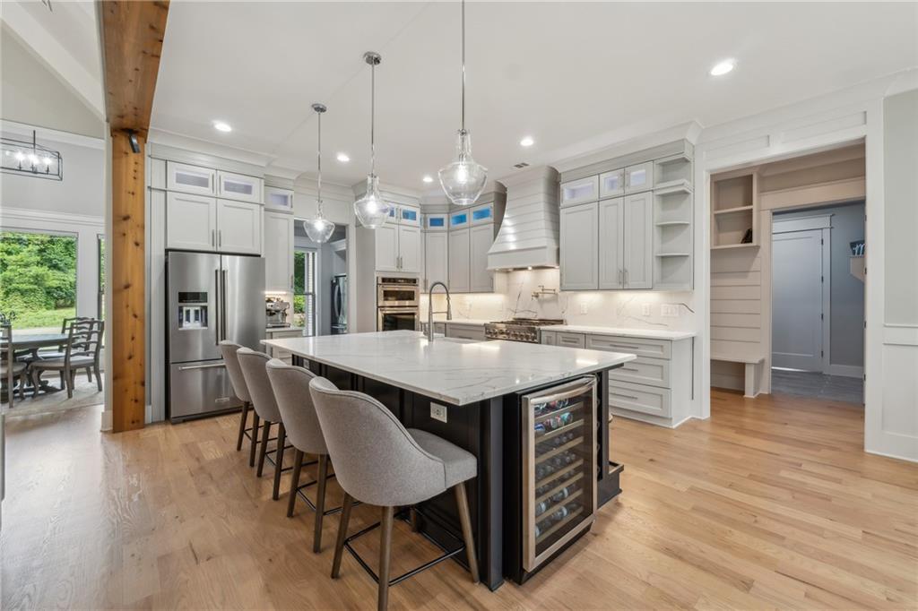 852 Tom Miller Road Bethlehem, GA 30620 - Photo 21 of 68 a kitchen with stainless steel appliances kitchen island granite countertop a table chairs and a refrigerator