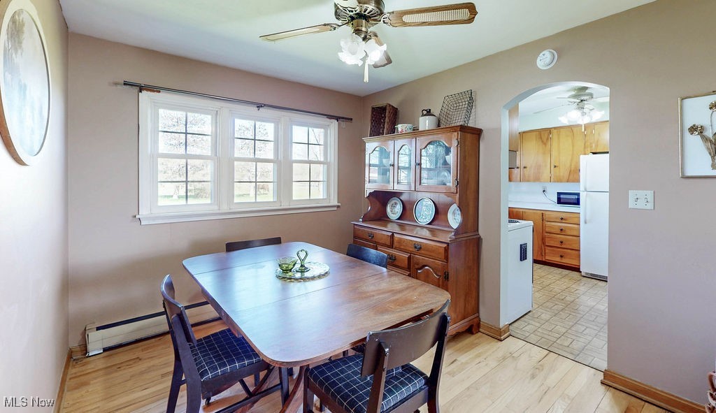 3464 South Bailey Road North Jackson, OH 44451 - Photo 12 of 33 Dining room with baseboards, arched walkways, a baseboard heating unit, a ceiling fan, and light wood finished floors