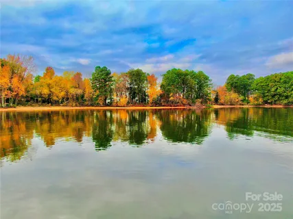 a body of water with a building in the background