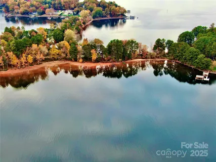 an aerial view of a house with a lake view