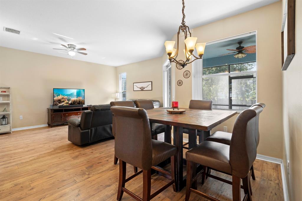 6480 Fall Street St. Cloud, FL 34771 - Photo 11 of 47 a view of a dining room with furniture window and wooden floor