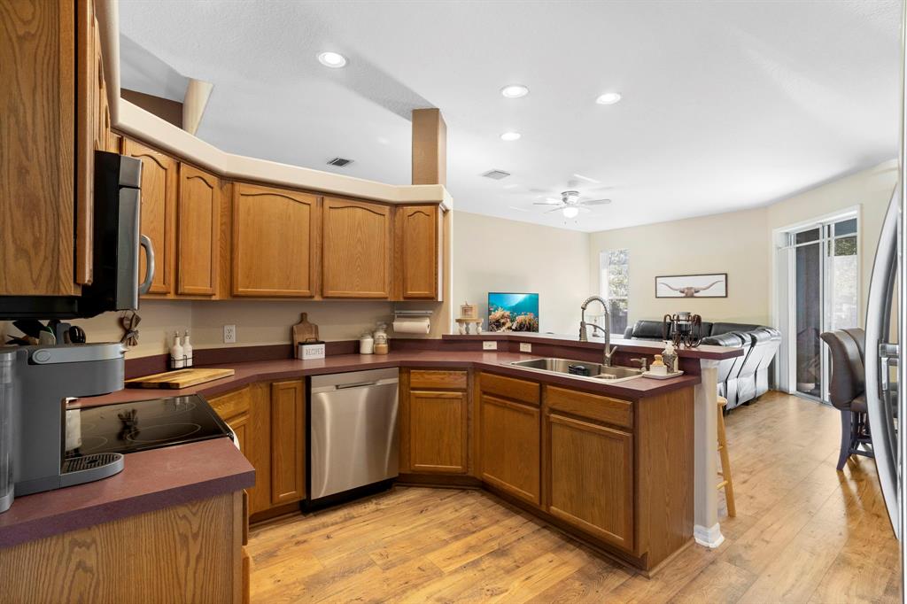 6480 Fall Street St. Cloud, FL 34771 - Photo 16 of 47 a kitchen with lots of counter top space sink and stainless steel appliances
