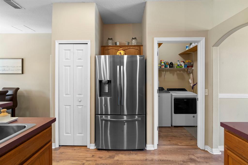 6480 Fall Street St. Cloud, FL 34771 - Photo 17 of 47 a kitchen with a refrigerator and a stove top oven