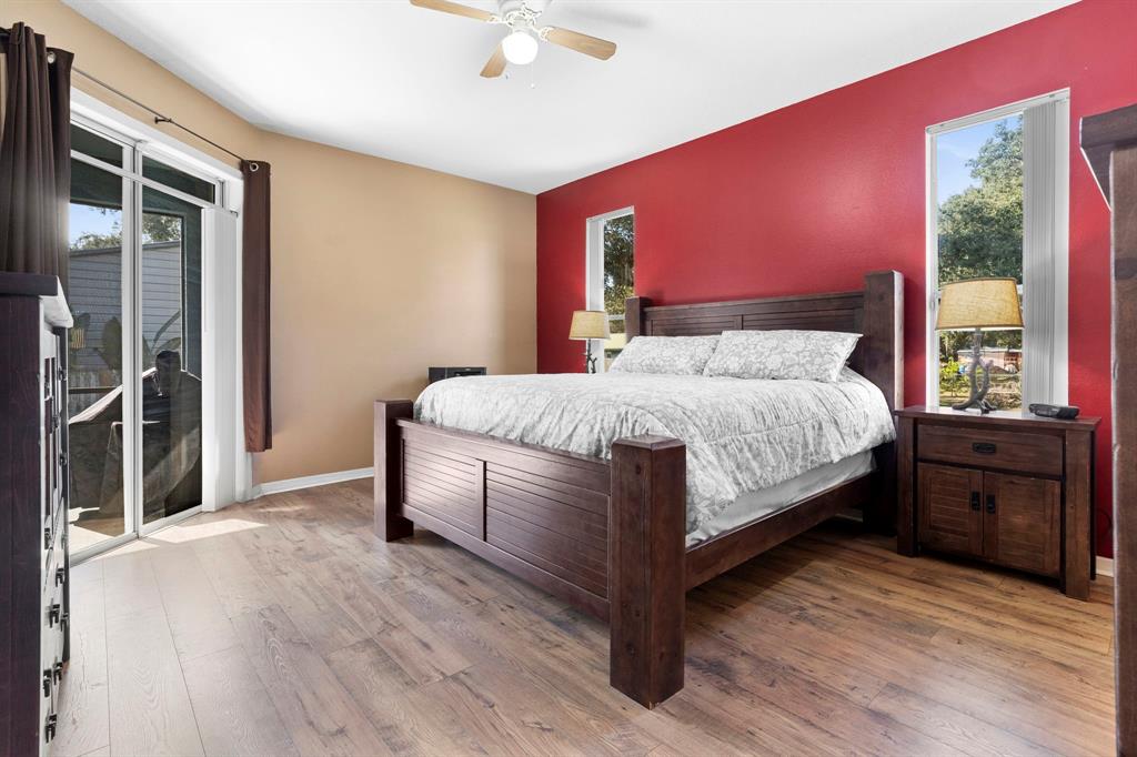 6480 Fall Street St. Cloud, FL 34771 - Photo 19 of 47 a bedroom with a bed and a dresser next to a window