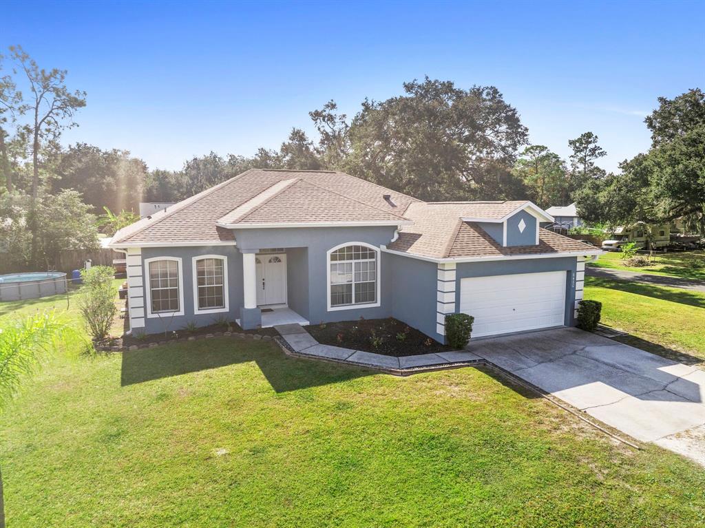 6480 Fall Street St. Cloud, FL 34771 - Photo 2 of 47 a front view of a house with a yard