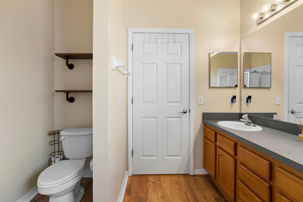 6480 Fall Street St. Cloud, FL 34771 - Photo 23 of 47 a bathroom with a granite countertop sink toilet and mirror