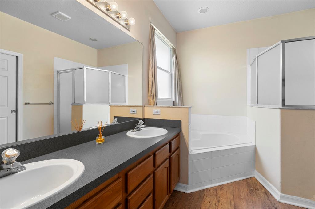 6480 Fall Street St. Cloud, FL 34771 - Photo 24 of 47 a bathroom with a sink double vanity granite tub shower and a mirror