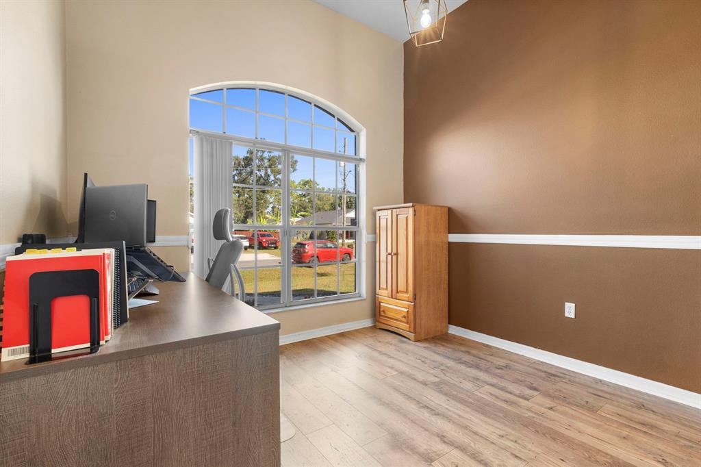 6480 Fall Street St. Cloud, FL 34771 - Photo 34 of 47 a kitchen with stainless steel appliances granite countertop a refrigerator a stove and a wooden floor