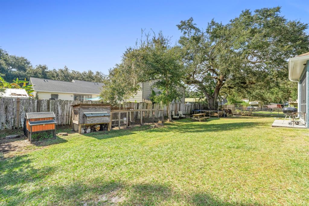 6480 Fall Street St. Cloud, FL 34771 - Photo 39 of 47 a view of a swimming pool with a bench and trees