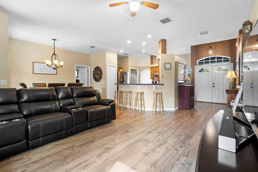 6480 Fall Street St. Cloud, FL 34771 - Photo 6 of 47 a living room with furniture and a chandelier