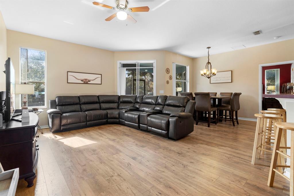 6480 Fall Street St. Cloud, FL 34771 - Photo 8 of 47 a living room with furniture a dining table and wooden floor