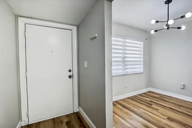 a bathroom with a toilet a sink a mirror a bathtub and vanity