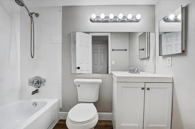 a view of a room with wooden floor and bathroom