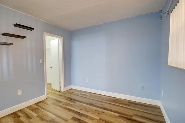 a view of a room with a ceiling fan and a window