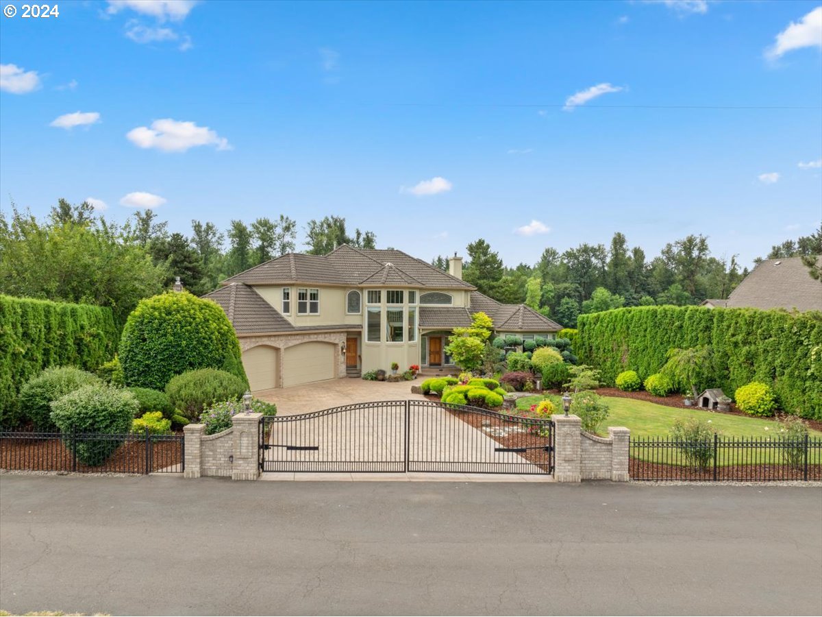 front view of a house with a yard and potted plants