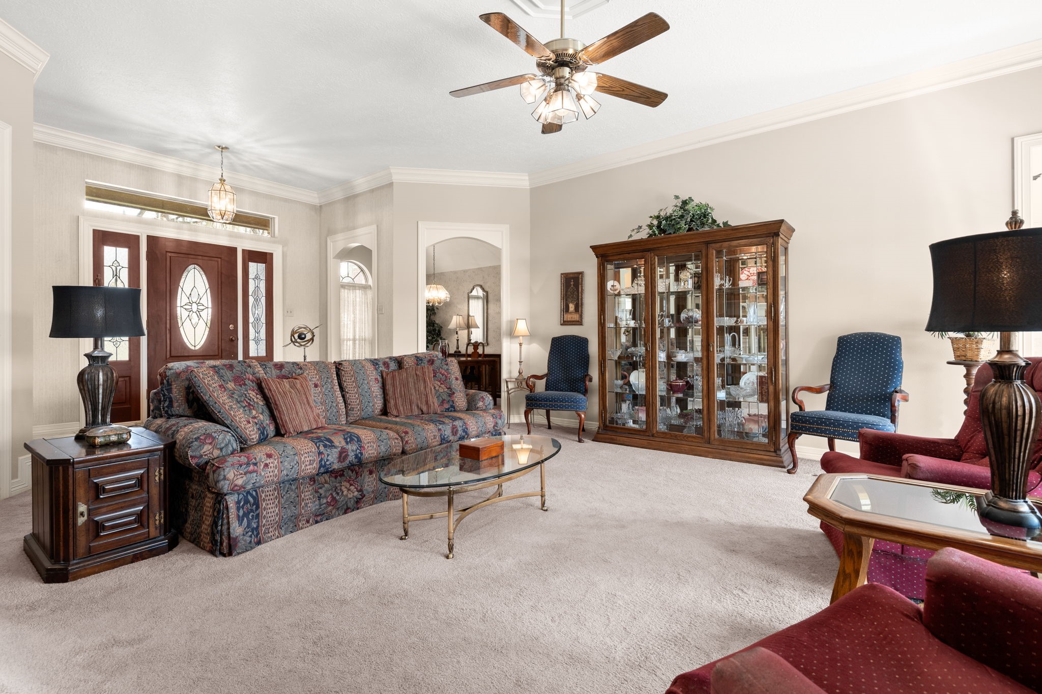 100 April Breeze Conroe, TX 77356 - Photo 11 of 40 Crown molding throughout with arched doorways leading into the formal dining space.