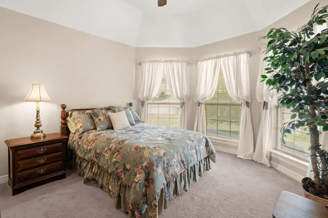 a bed sitting in a room next to a window