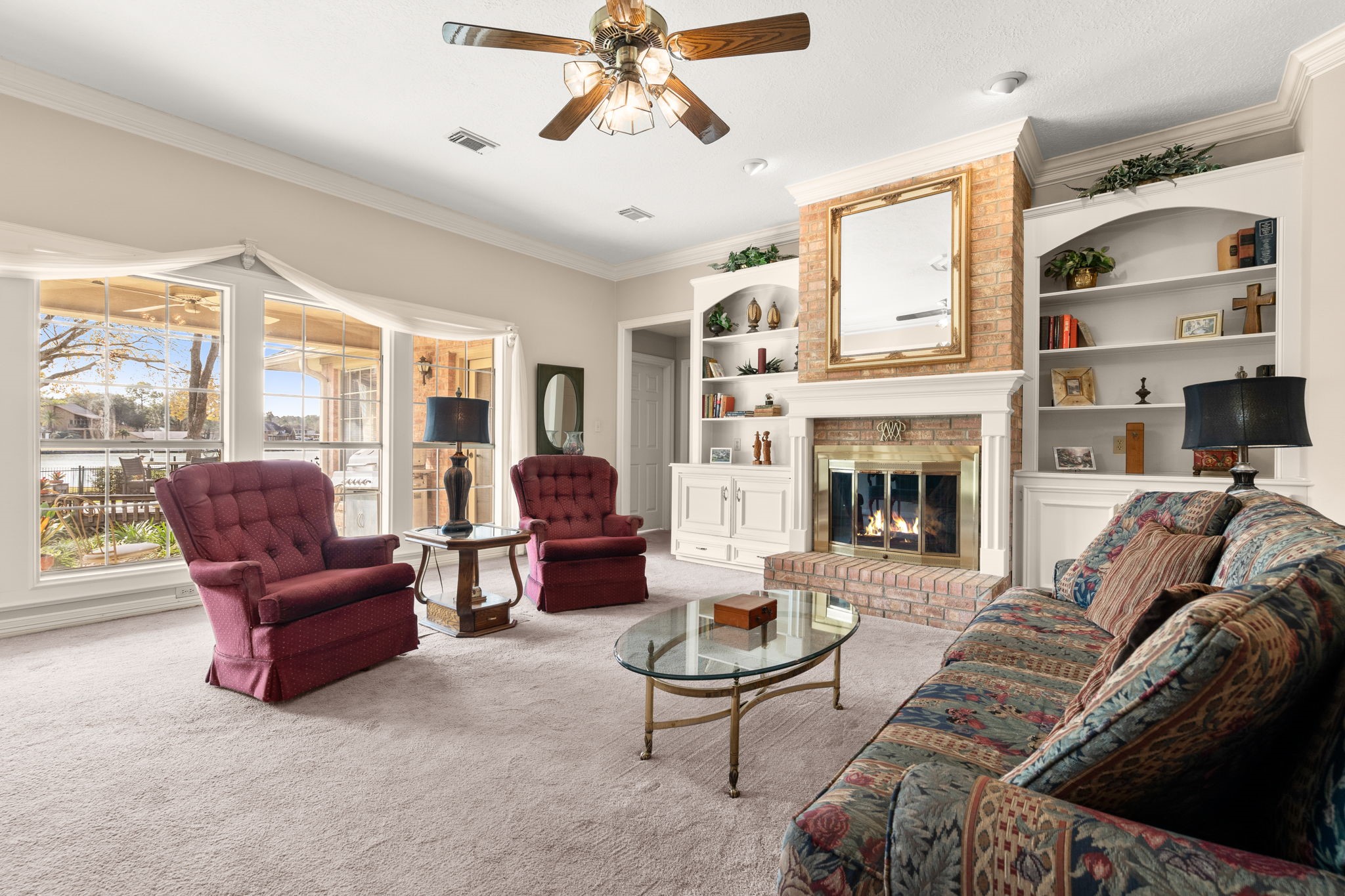 100 April Breeze Conroe, TX 77356 - Photo 9 of 40 Large living room with gas fireplace and large windows to enjoy the water views.