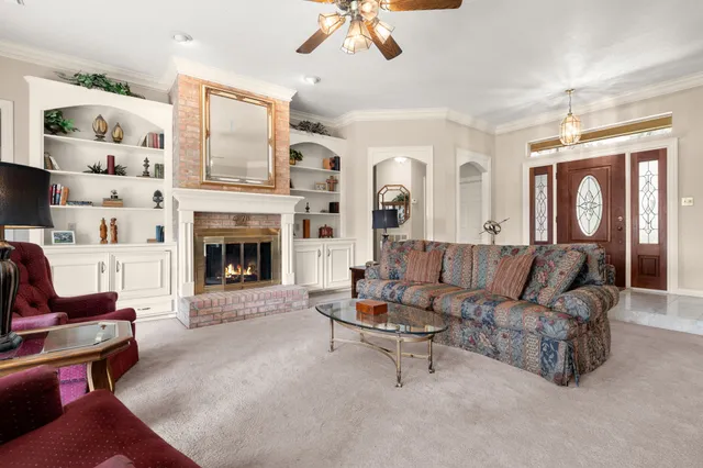a living room with furniture and a fireplace