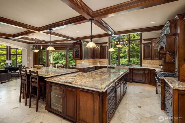 a kitchen with a stove a counter space a sink and cabinets