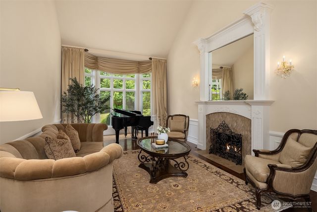 a living room with furniture rug and a fireplace