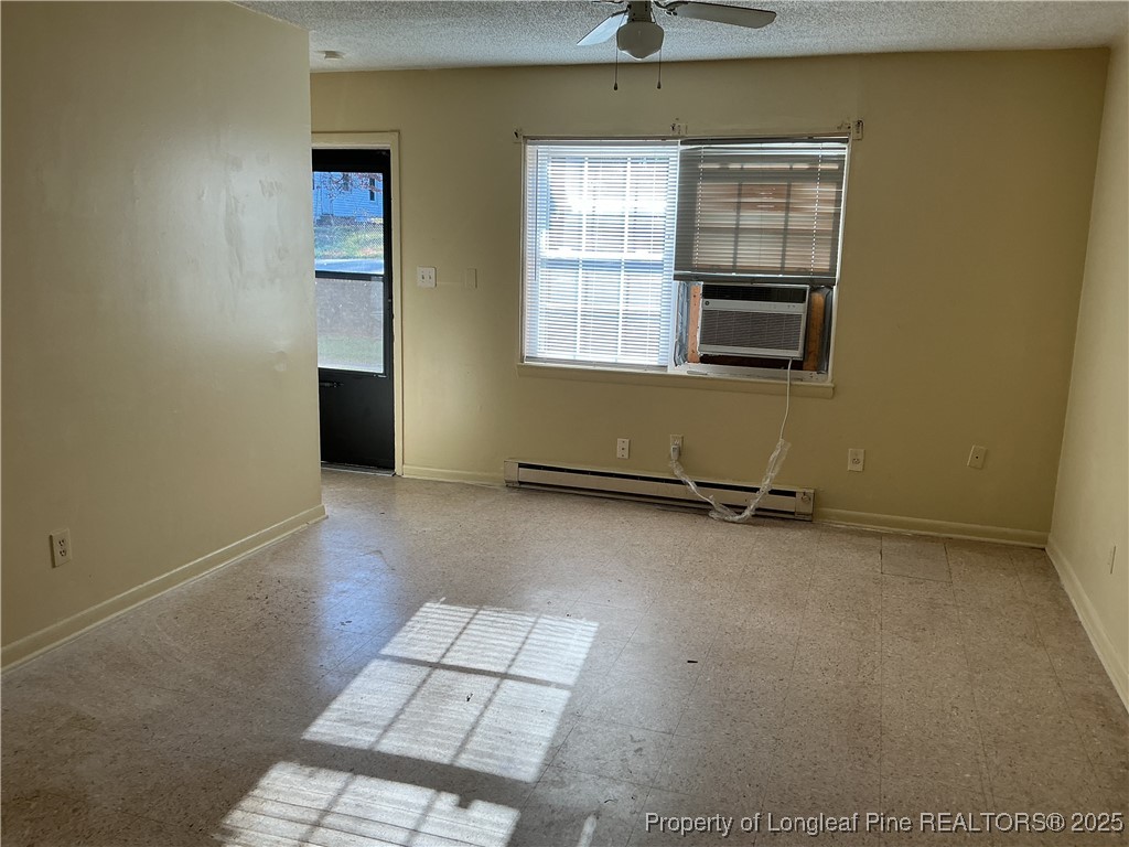 1708 B Newark Avenue Fayetteville, NC 28301 - Photo 2 of 5 an empty room with windows