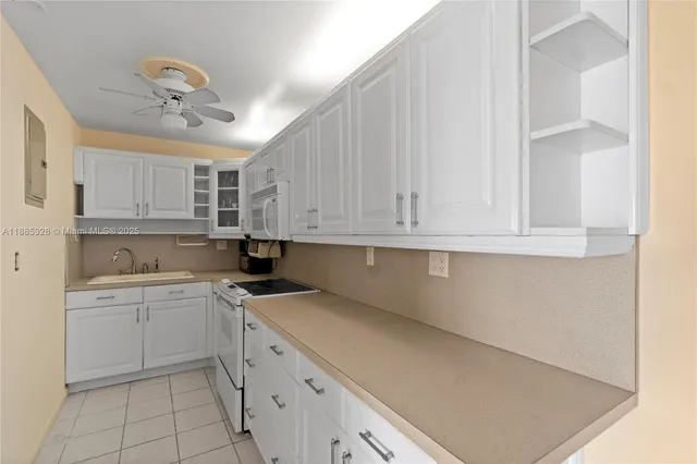 a kitchen with stainless steel appliances a refrigerator sink and cabinets