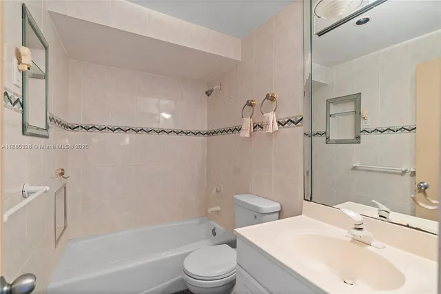 a bathroom with a toilet sink and shower