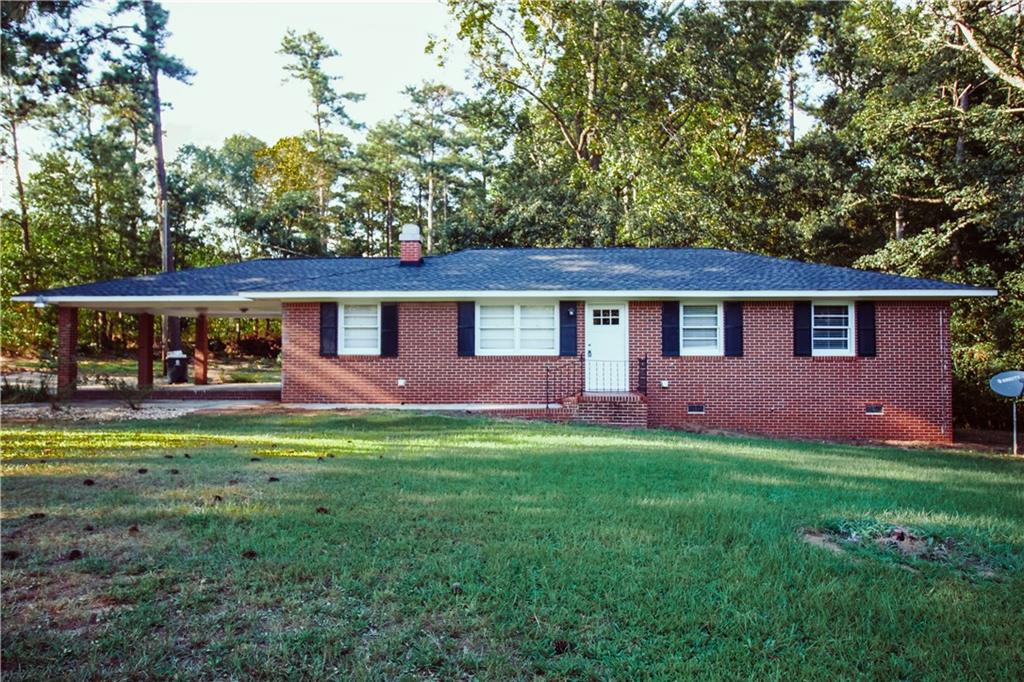 647 Hillview Road Hampton, GA 30228 - Photo 1 of 1 a front view of a house with a garden