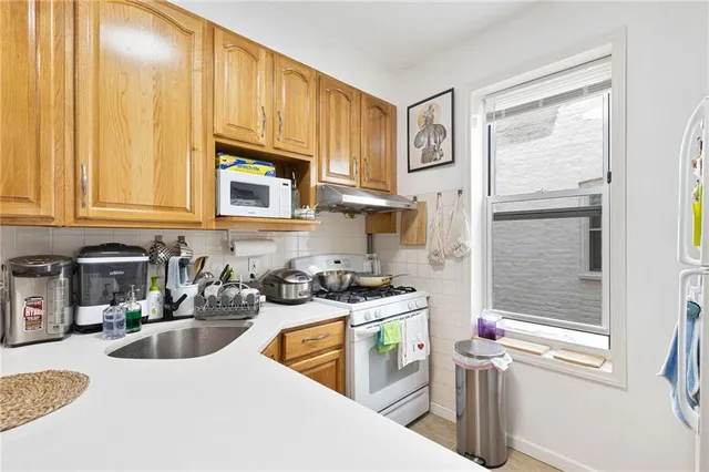 a kitchen with stainless steel appliances granite countertop a sink stove and cabinets