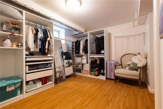 a view of a room with wooden floor and closet