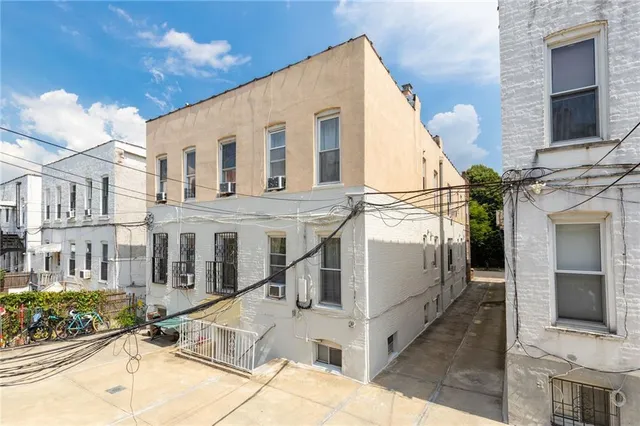 a view of a white building with many windows