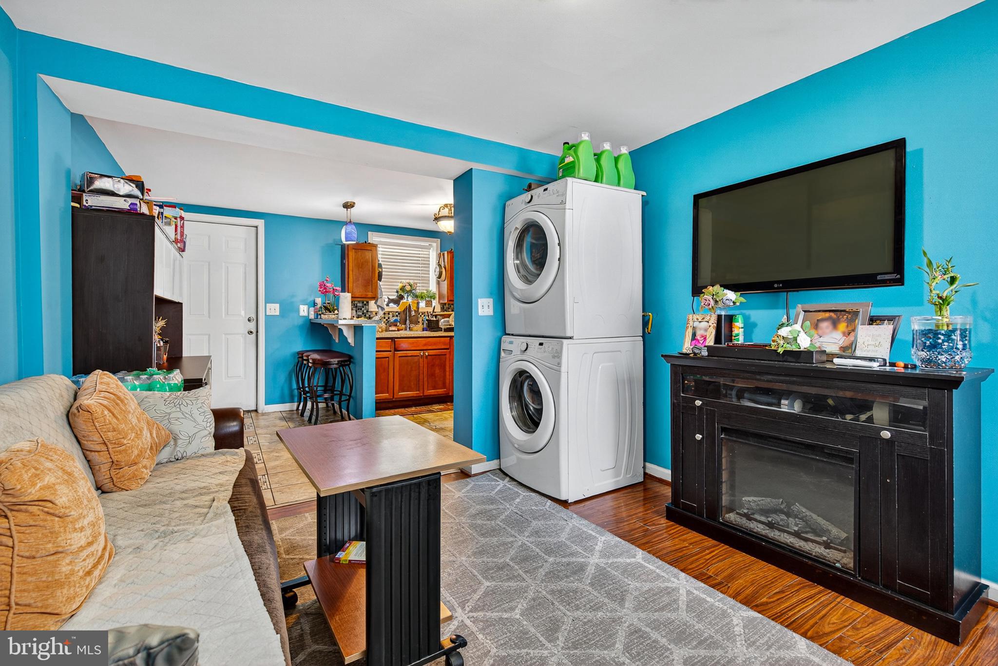 1109 Quantril Way Baltimore, MD 21205 - Photo 2 of 18 a living room with furniture a flat screen tv and a fireplace