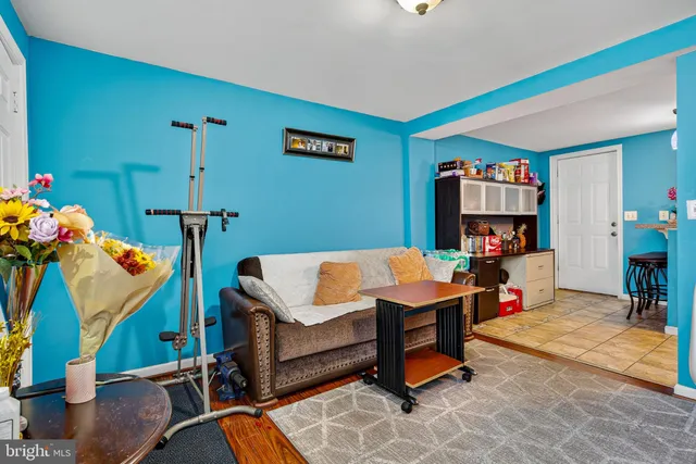 a living room with furniture gym equipment and a table
