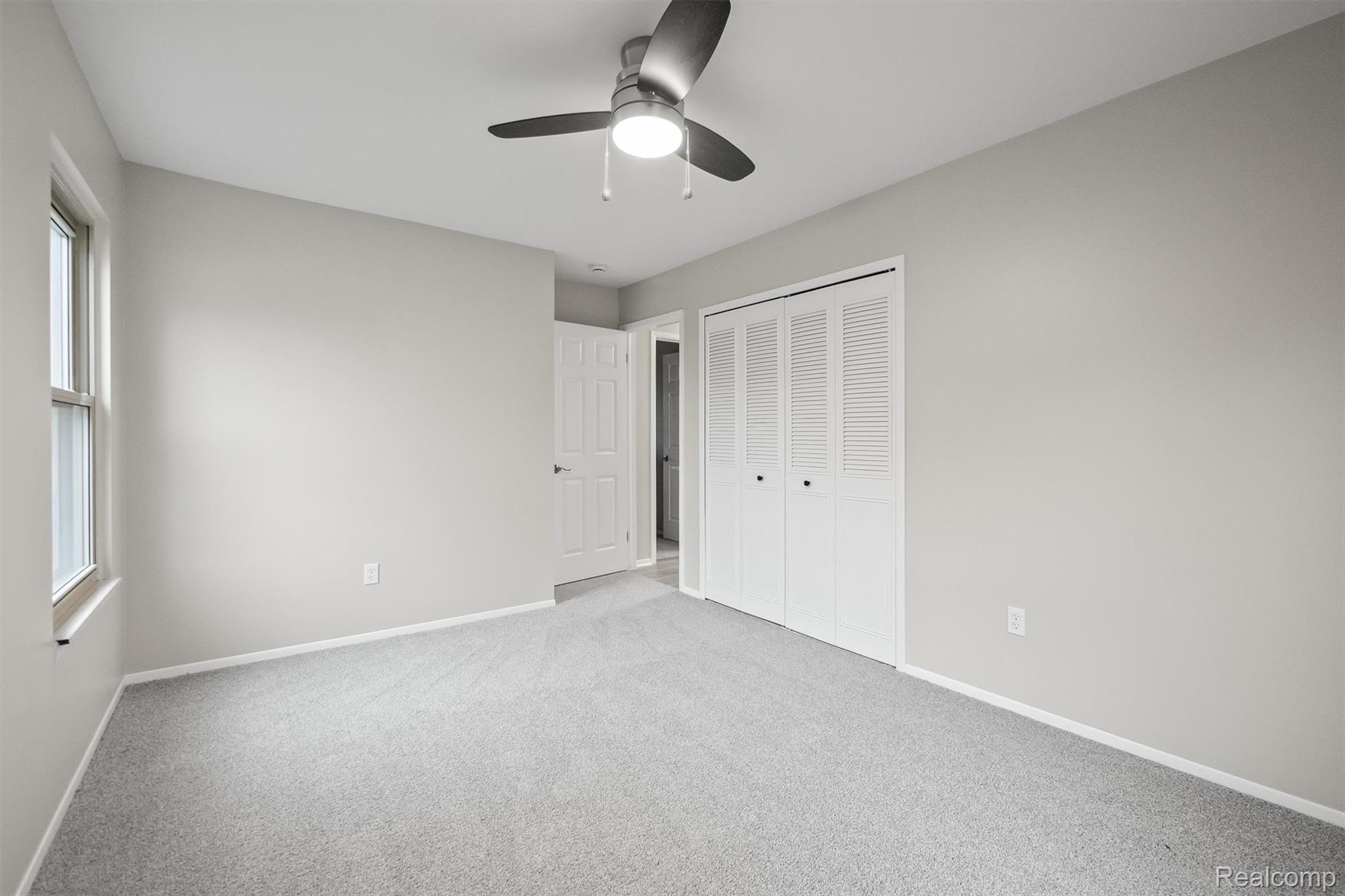 11326 Common Road Warren, MI 48093 - Photo 30 of 35 Unfurnished bedroom featuring light carpet, a closet, and ceiling fan