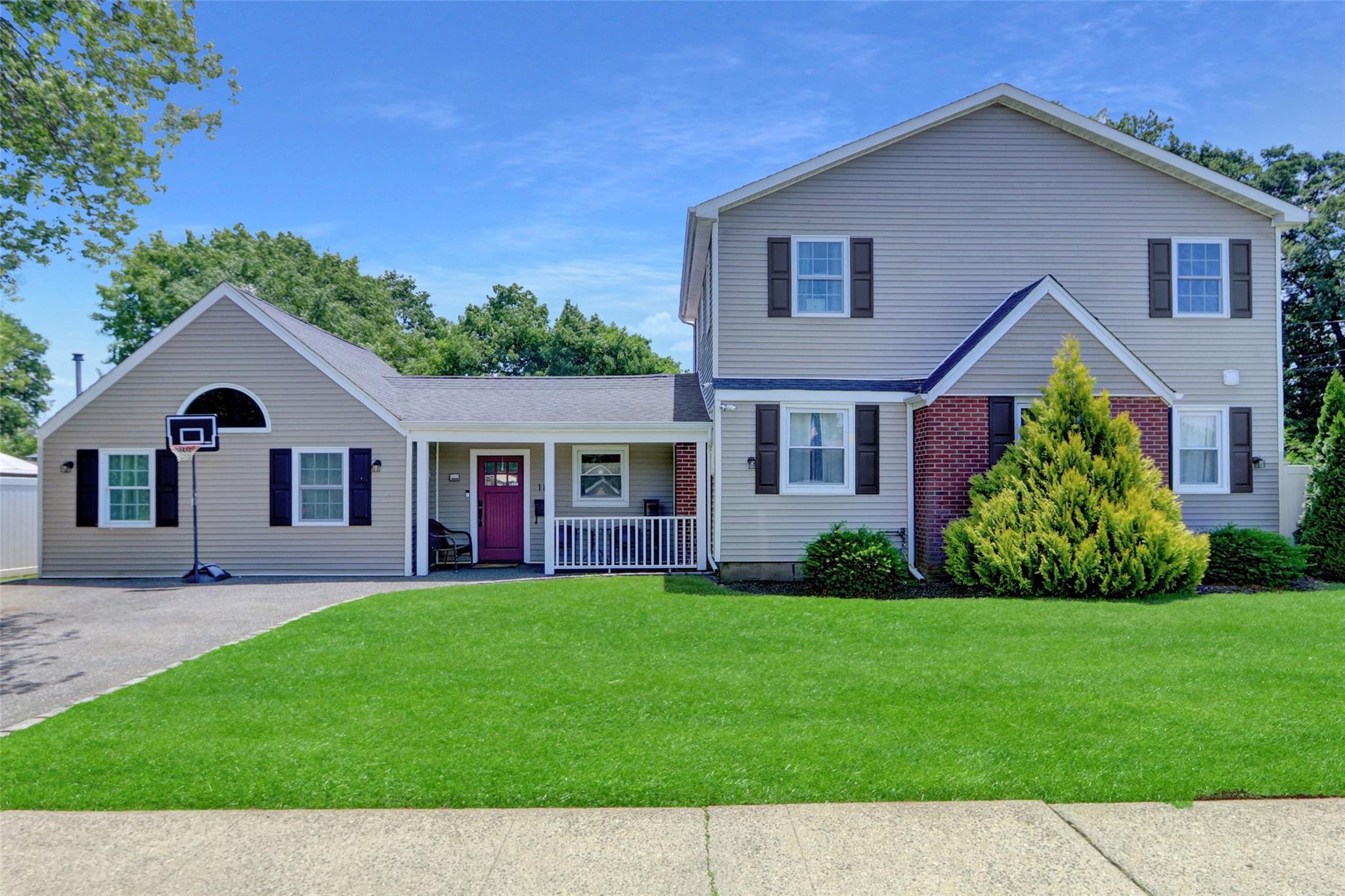 a front view of house with yard and green space