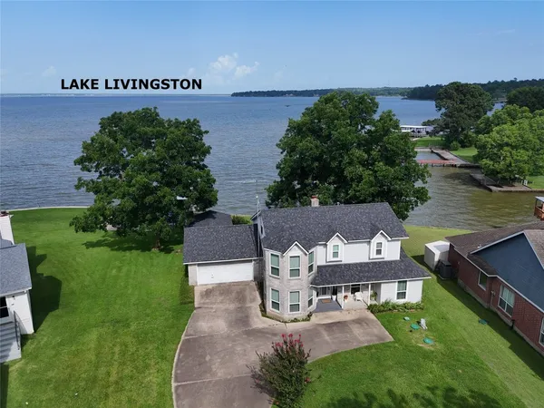 an aerial view of a house with garden space and street view