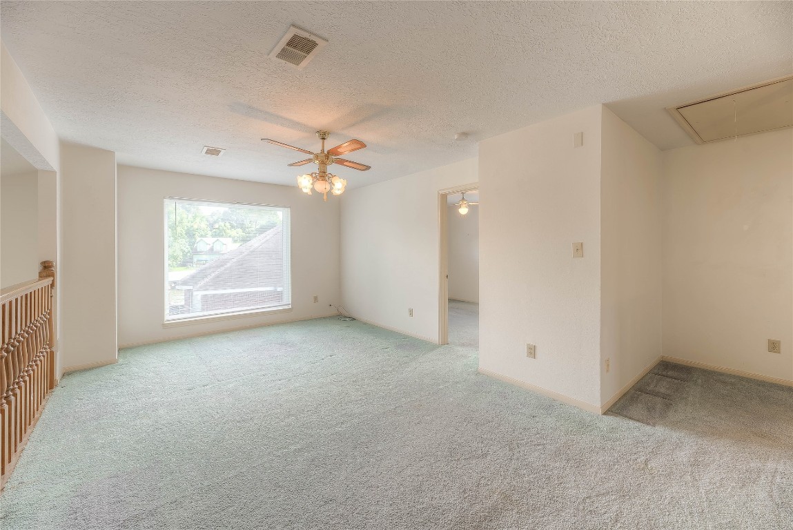 440 Lakeview Dr Loop Coldspring, TX 77331 - Photo 16 of 44 an empty room with windows and ceiling fan
