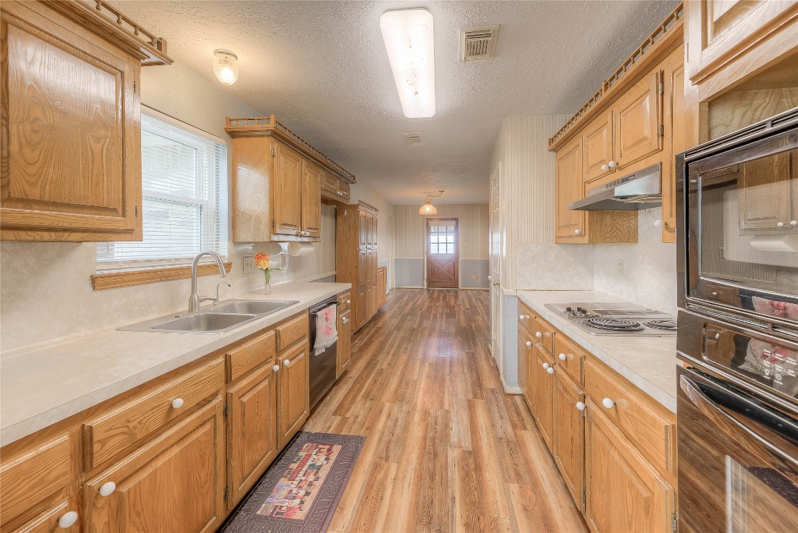 440 Lakeview Dr Loop Coldspring, TX 77331 - Photo 17 of 44 a kitchen with stainless steel appliances granite countertop a lot of counter space and wooden floors