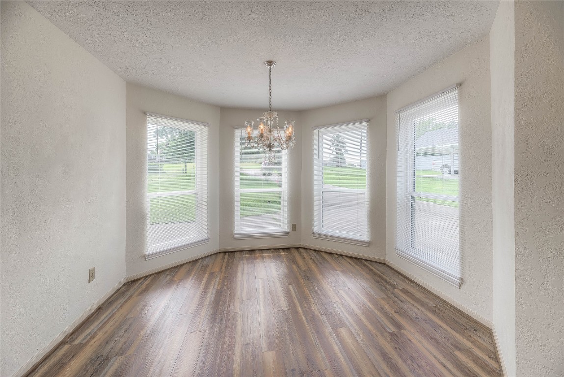 440 Lakeview Dr Loop Coldspring, TX 77331 - Photo 19 of 44 an empty room with wooden floor and windows