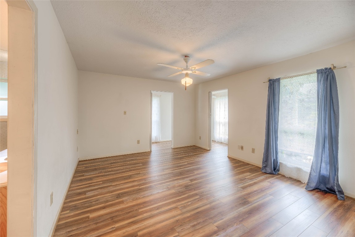 440 Lakeview Dr Loop Coldspring, TX 77331 - Photo 23 of 44 an empty room with wooden floor and a ceiling fan