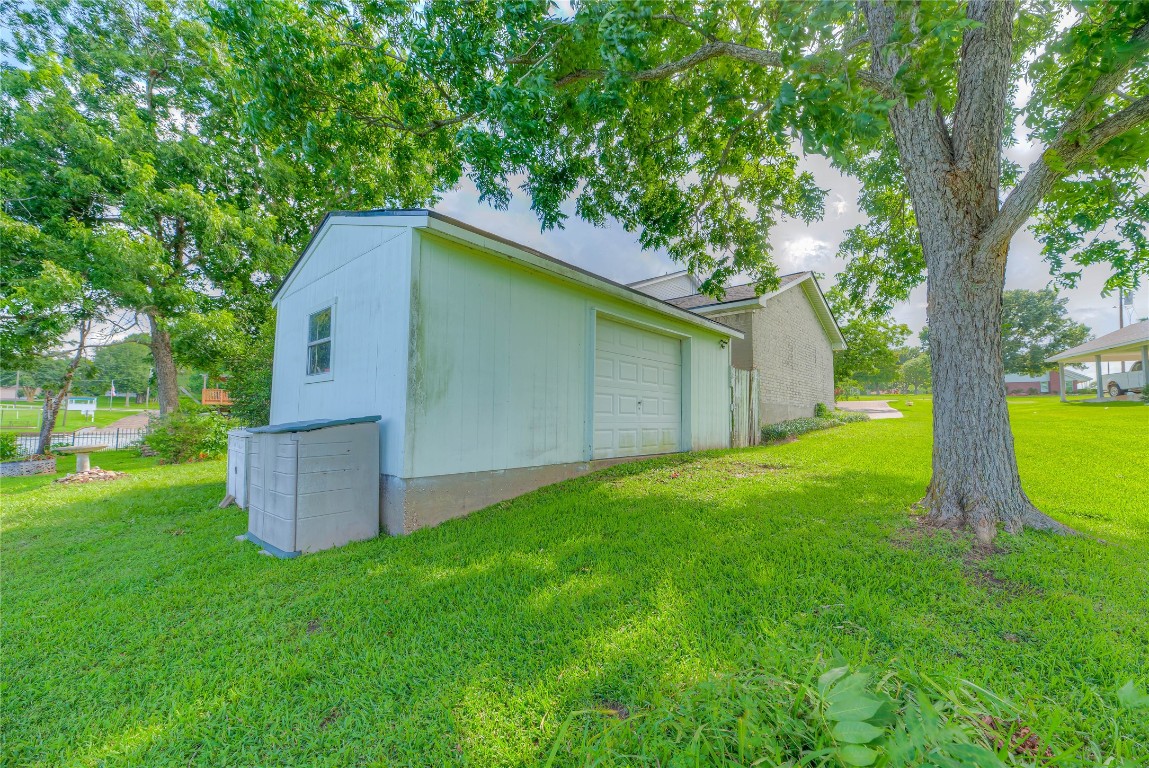 440 Lakeview Dr Loop Coldspring, TX 77331 - Photo 33 of 44 a view of a backyard with a barn and large trees