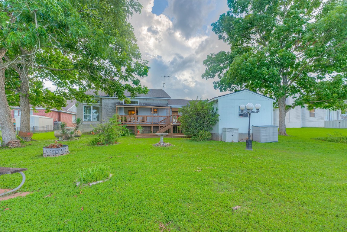 440 Lakeview Dr Loop Coldspring, TX 77331 - Photo 37 of 44 a backyard of a house with plants and large trees