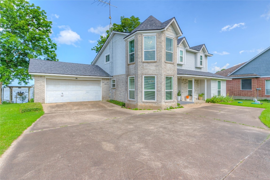 440 Lakeview Dr Loop Coldspring, TX 77331 - Photo 5 of 44 a front view of a house with a yard and garage