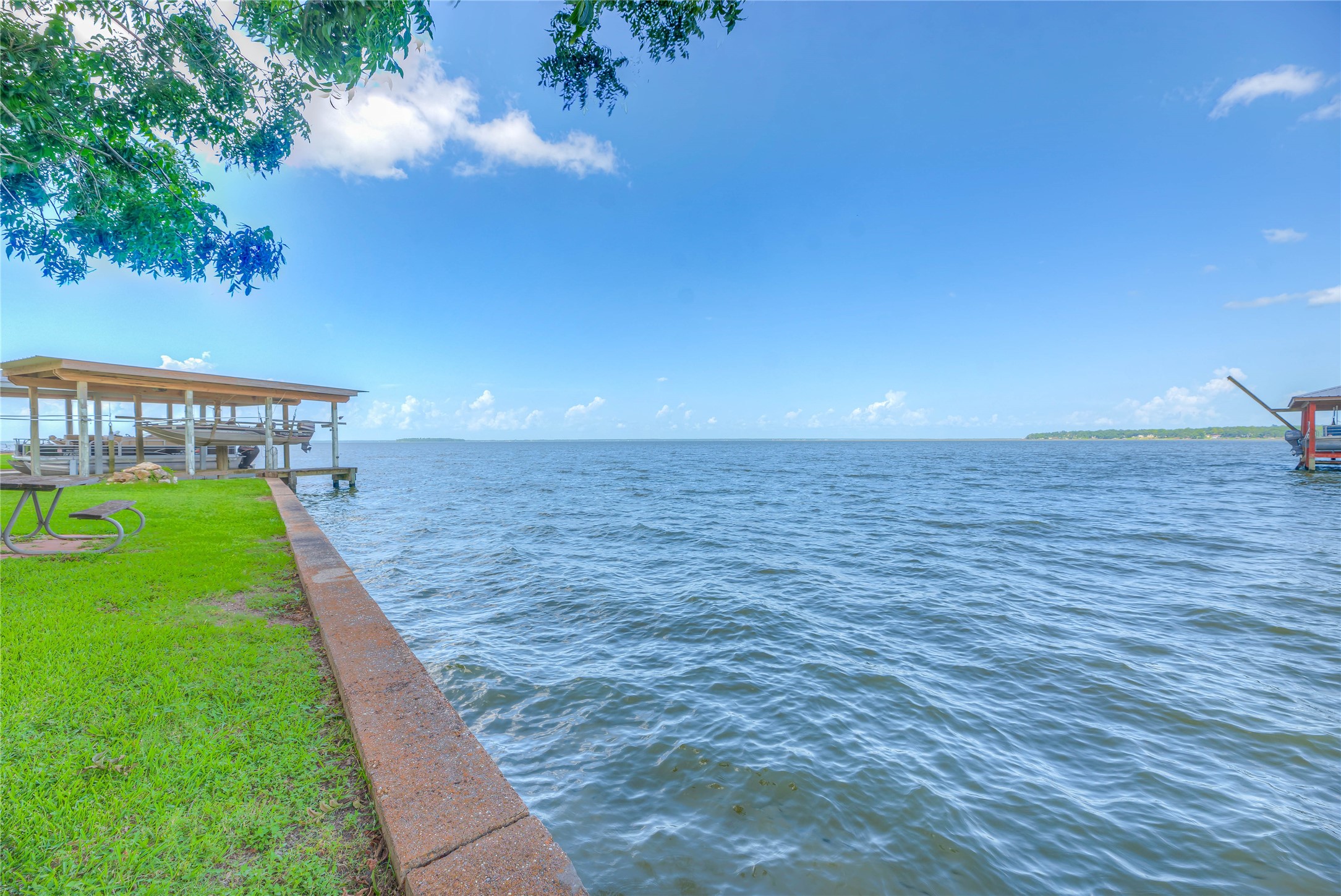 440 Lakeview Dr Loop Coldspring, TX 77331 - Photo 6 of 44 110 FOOT OF CONCRETE BULK HEAD.BOAT HOUSE AND FISHING DOCK --WHAT A VIEW