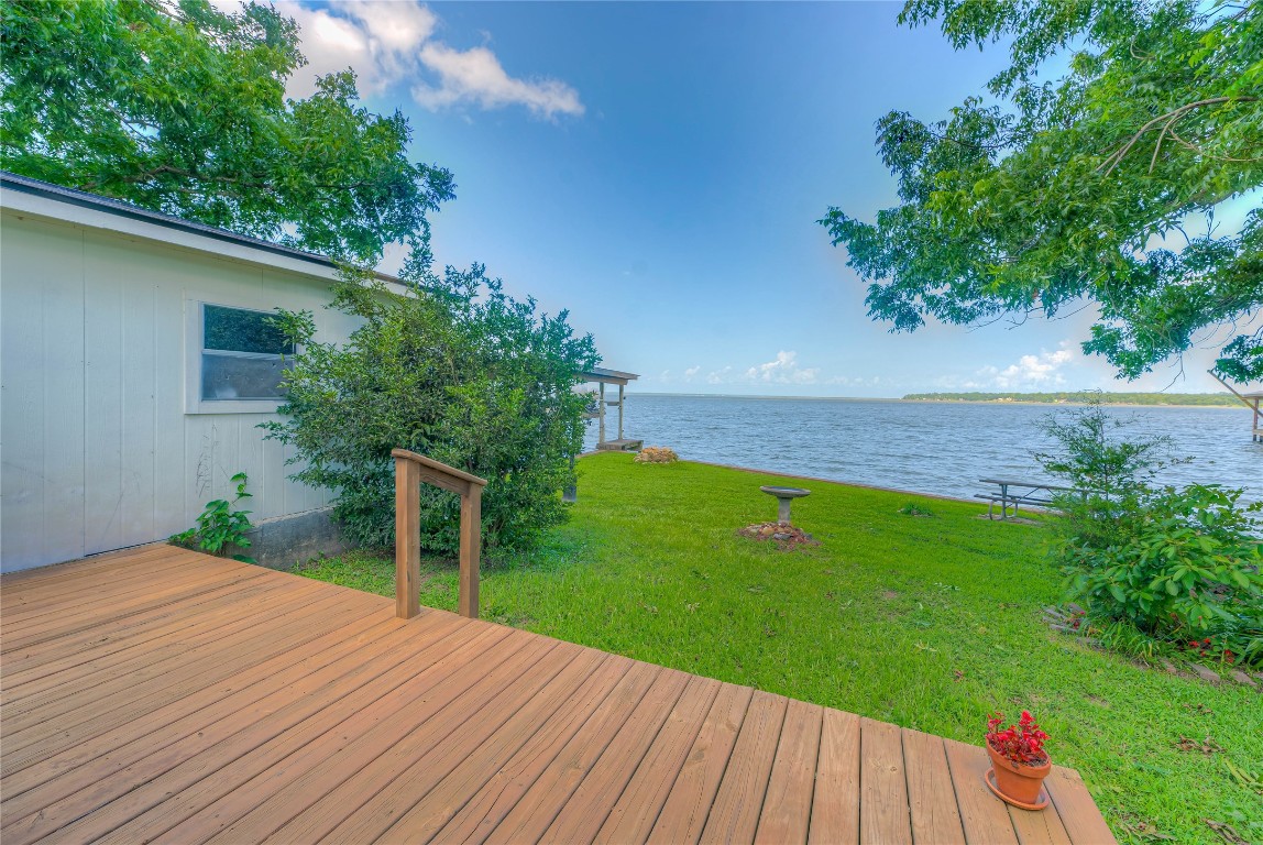 440 Lakeview Dr Loop Coldspring, TX 77331 - Photo 10 of 44 a view of a backyard with wooden floor and a large tree