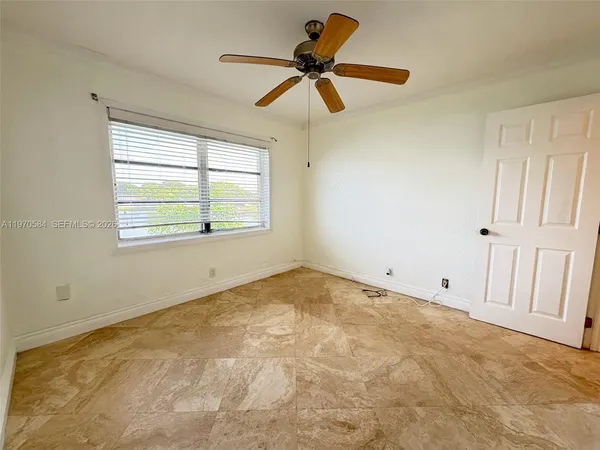 a view of an empty room and a window
