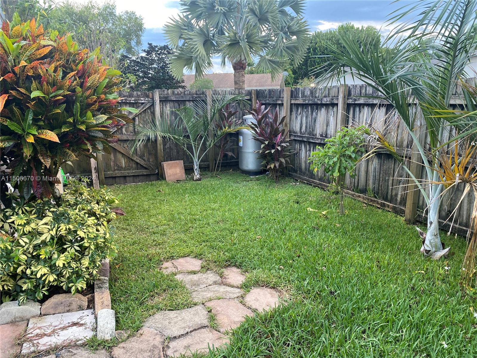 13341 Southwest 101st Street Miami, FL 33186 - Photo 24 of 43 a backyard of a house with lots of green space