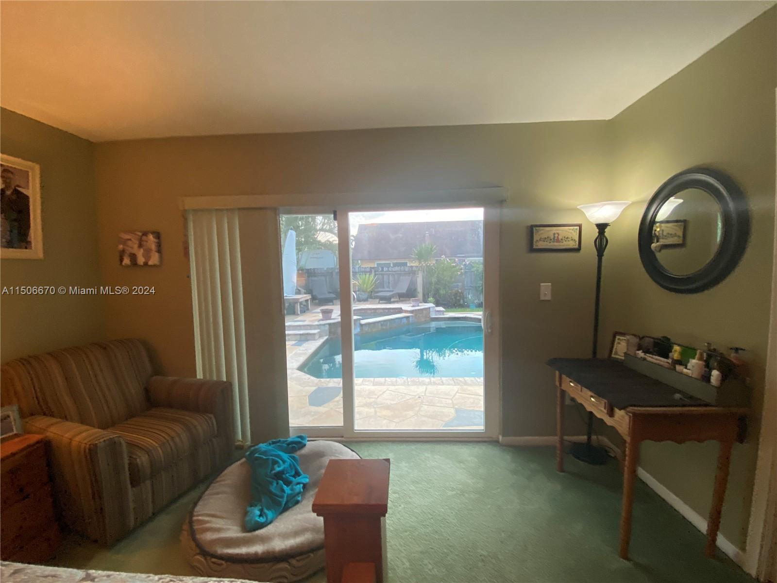 13341 Southwest 101st Street Miami, FL 33186 - Photo 26 of 43 a living room with furniture and a large window